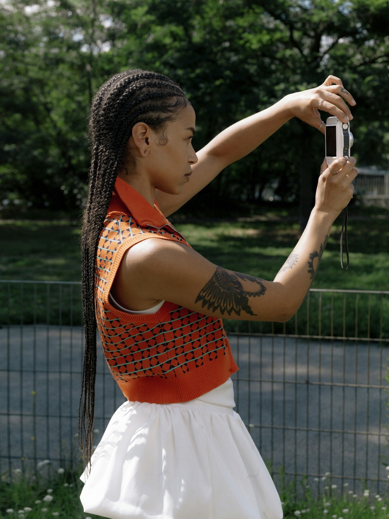 A woman taking a photo with a camera.