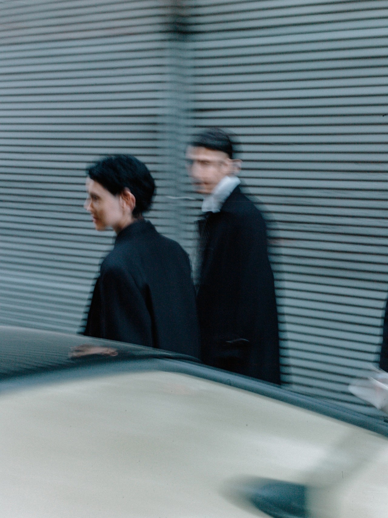 Two friends walking together down a street.