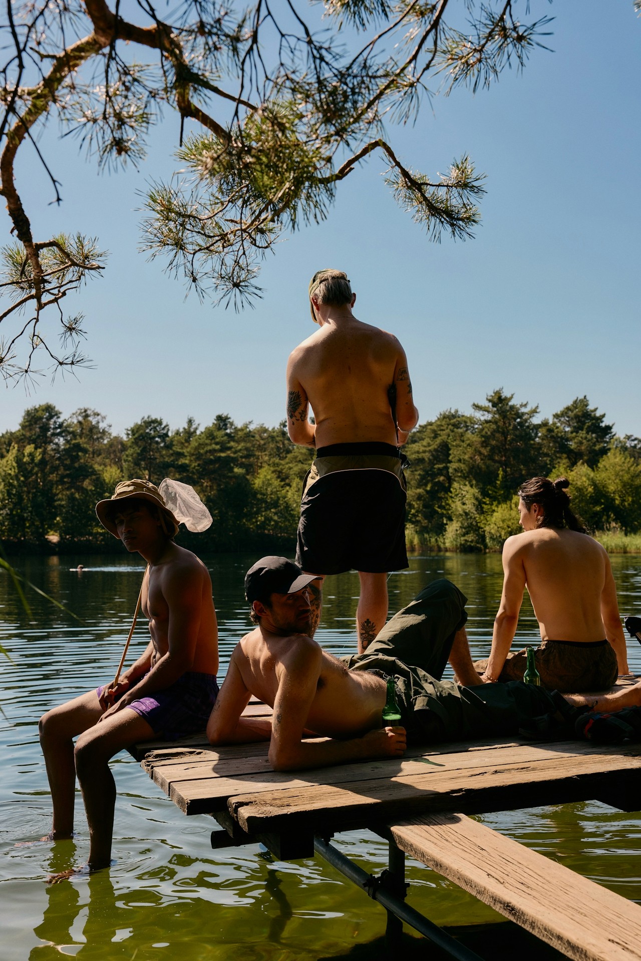 Friends fishing side by side outdoors.