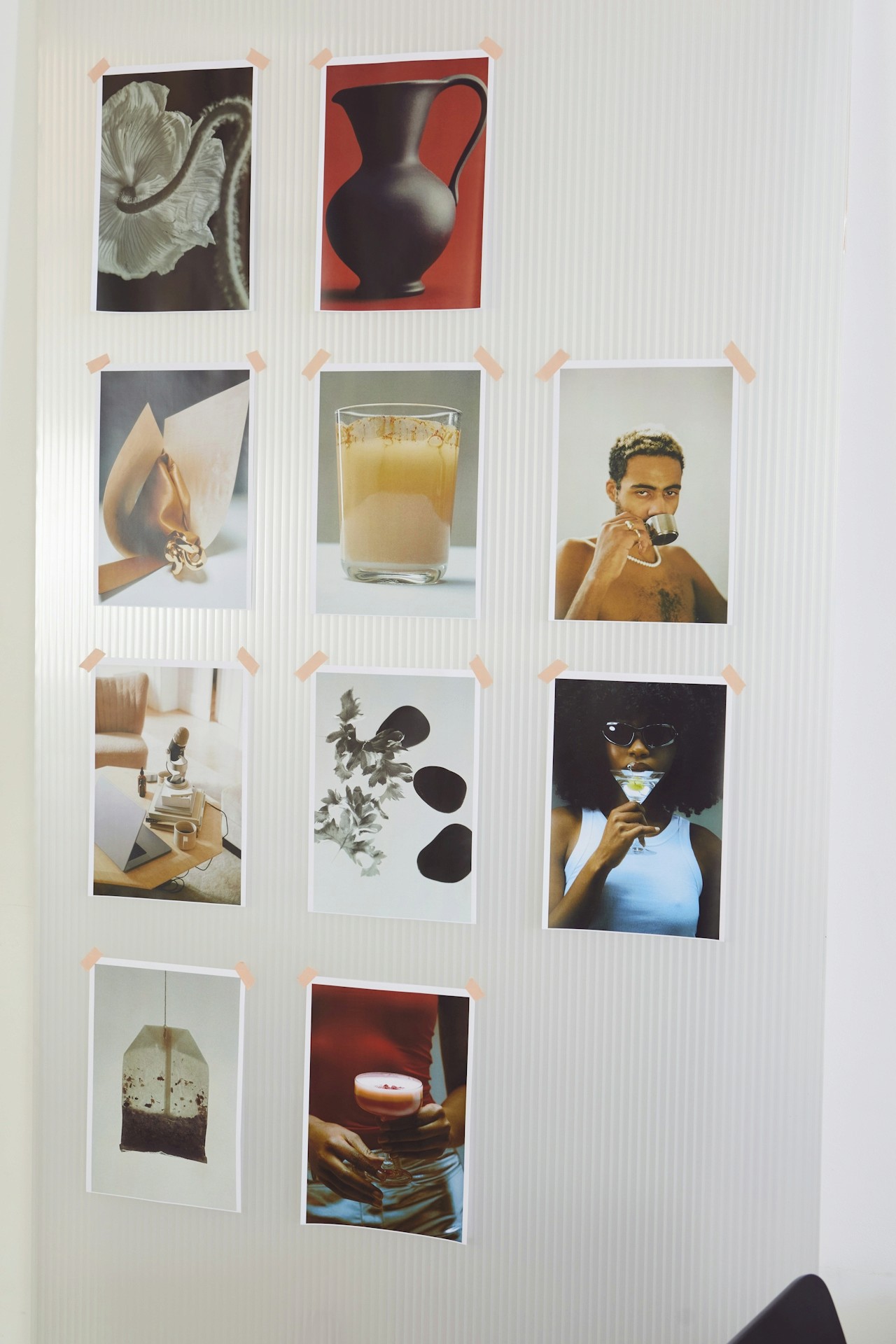 Photos taped to a wall.