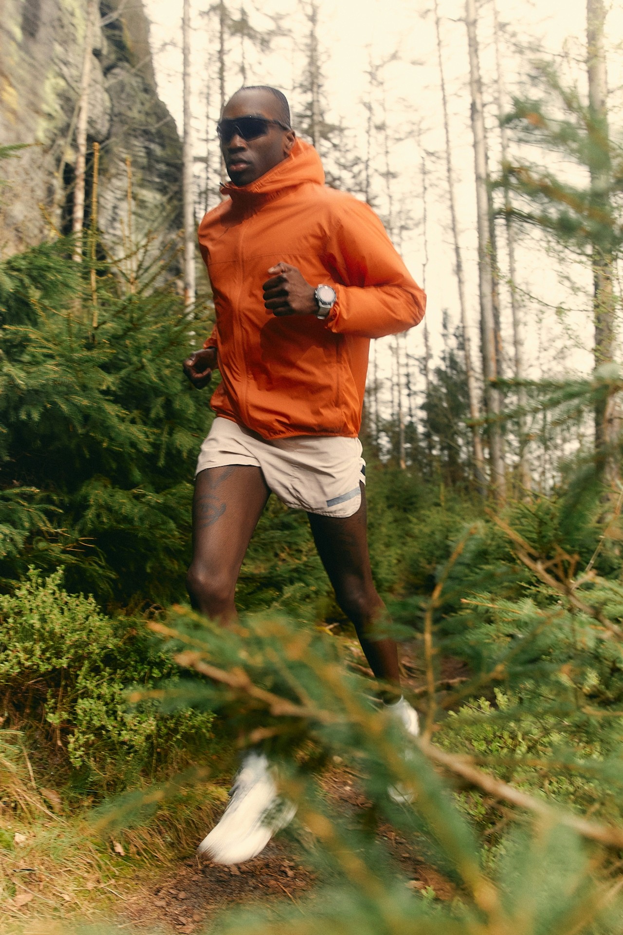 A man running along a forest path.