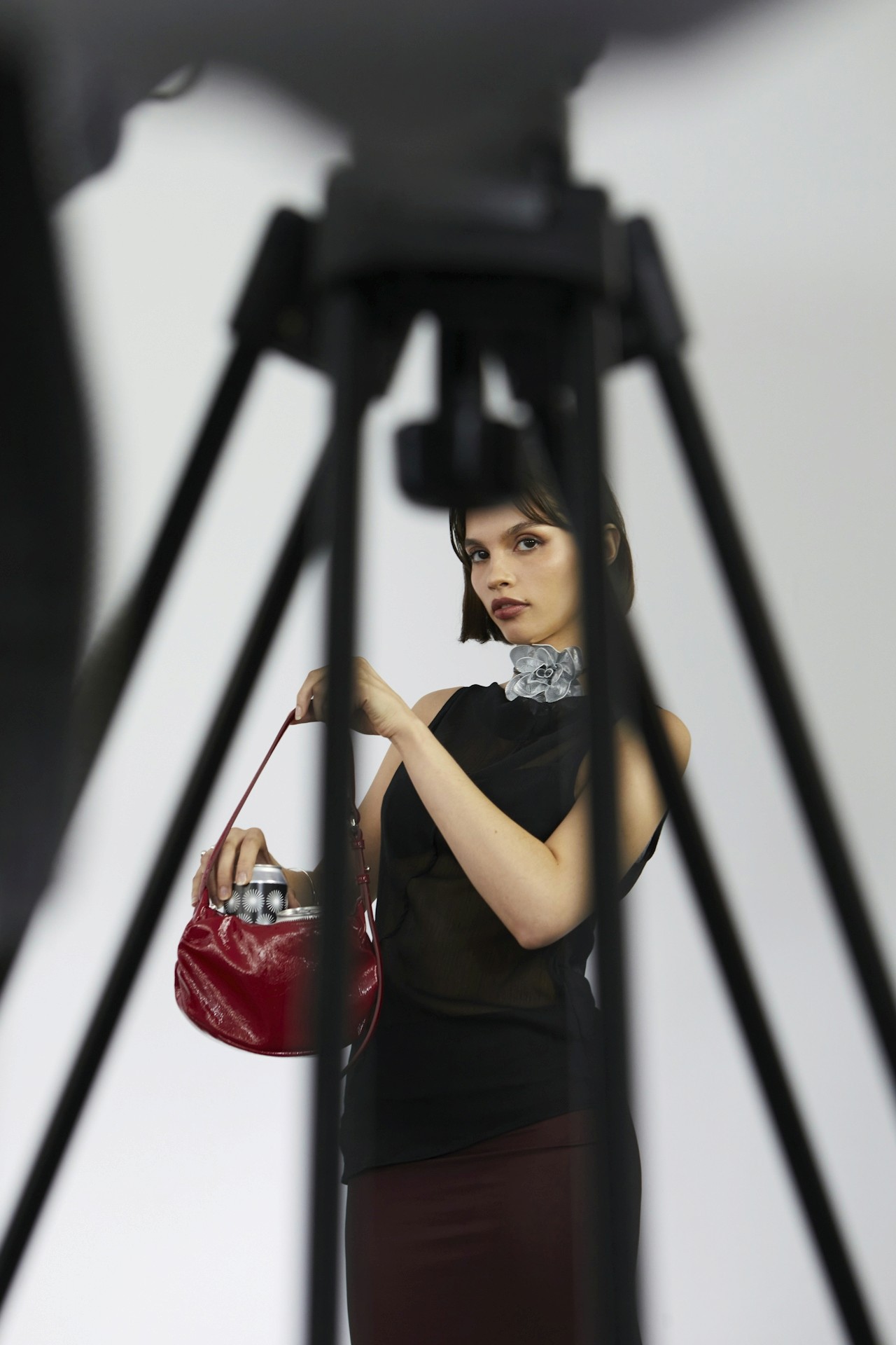A woman holding her brand product and posing for a photo.