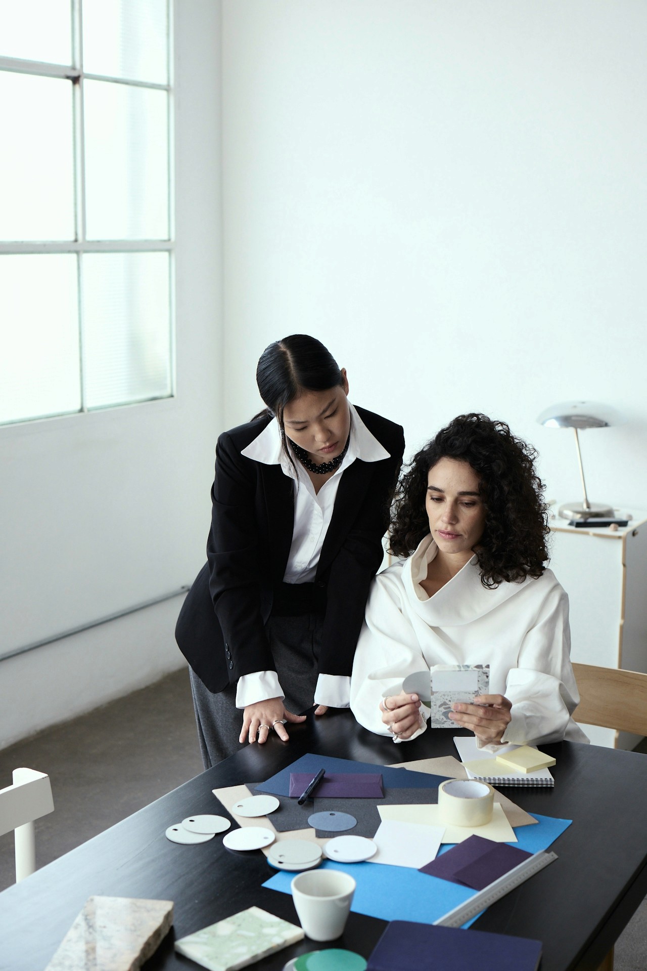 Two women having a focused discussion about a project.
