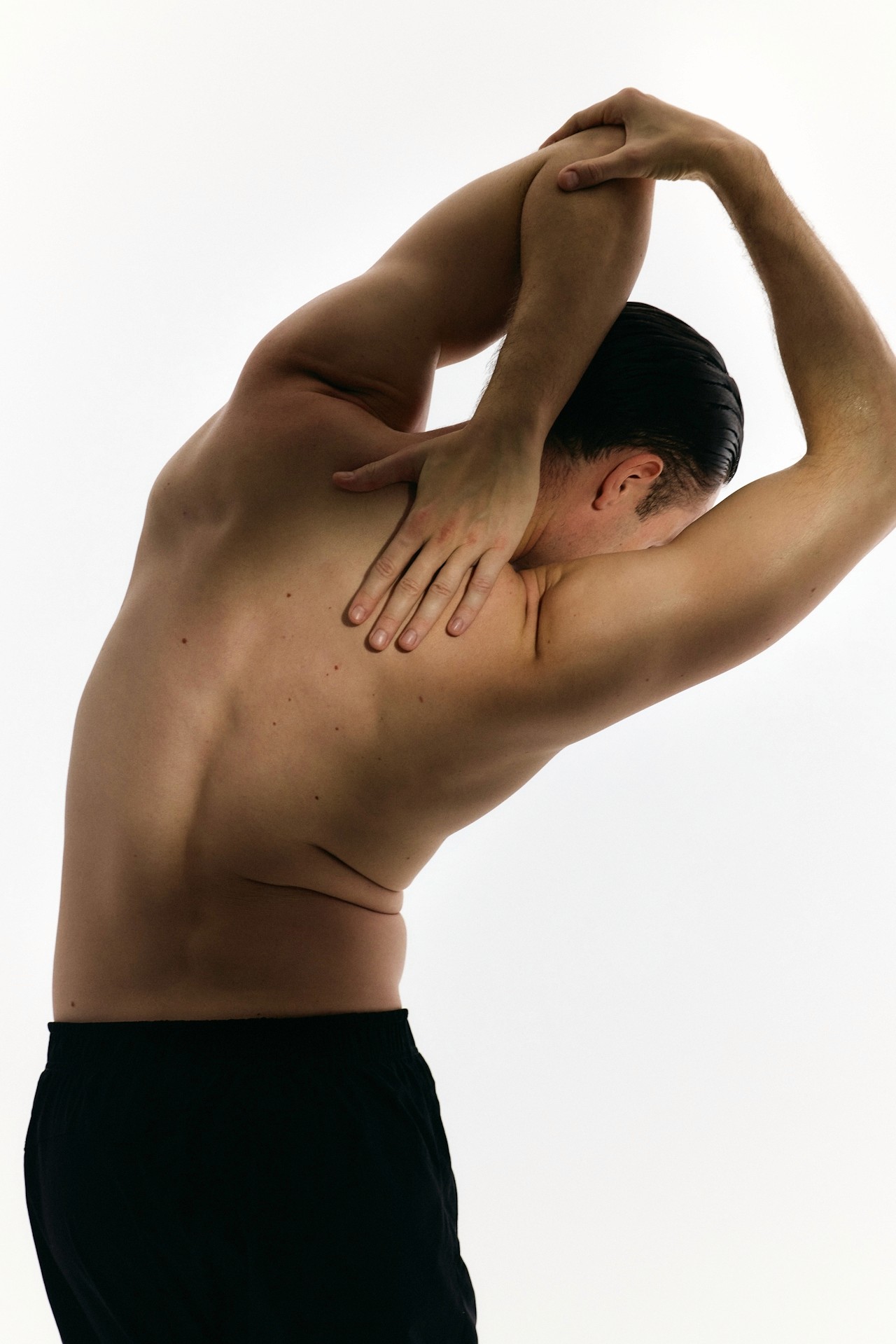 A person stretching their arm.