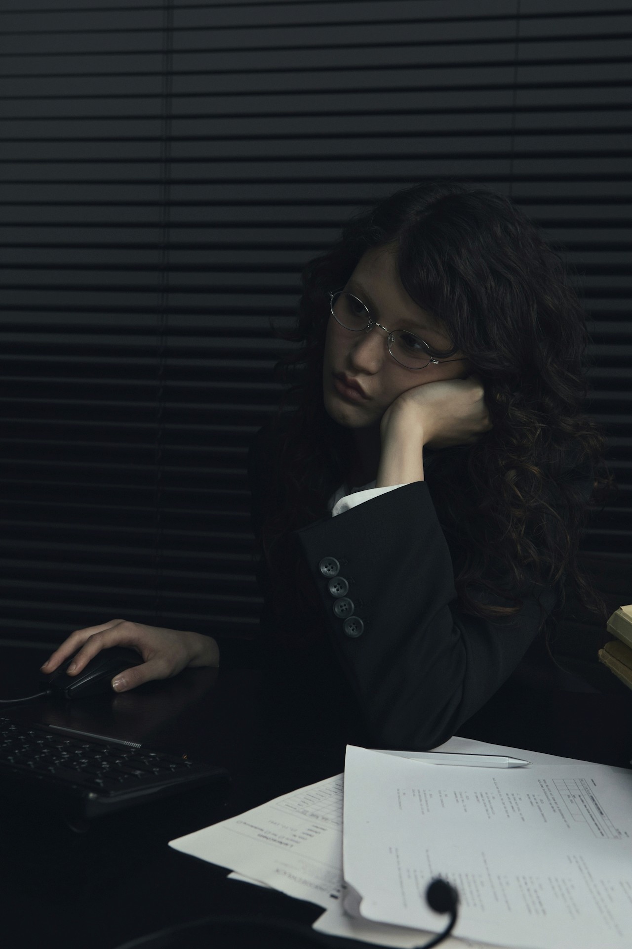 A women sitting in an office, looking worried.