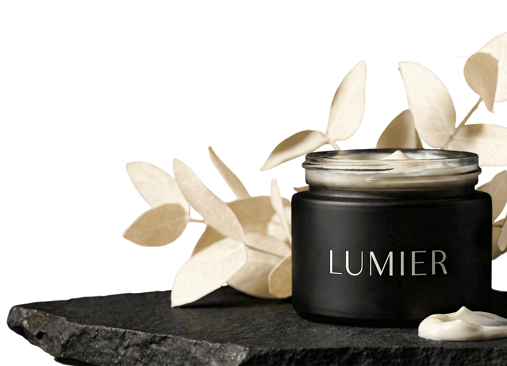 Woman with closed eyes, red hair, and a green leaf against her face.