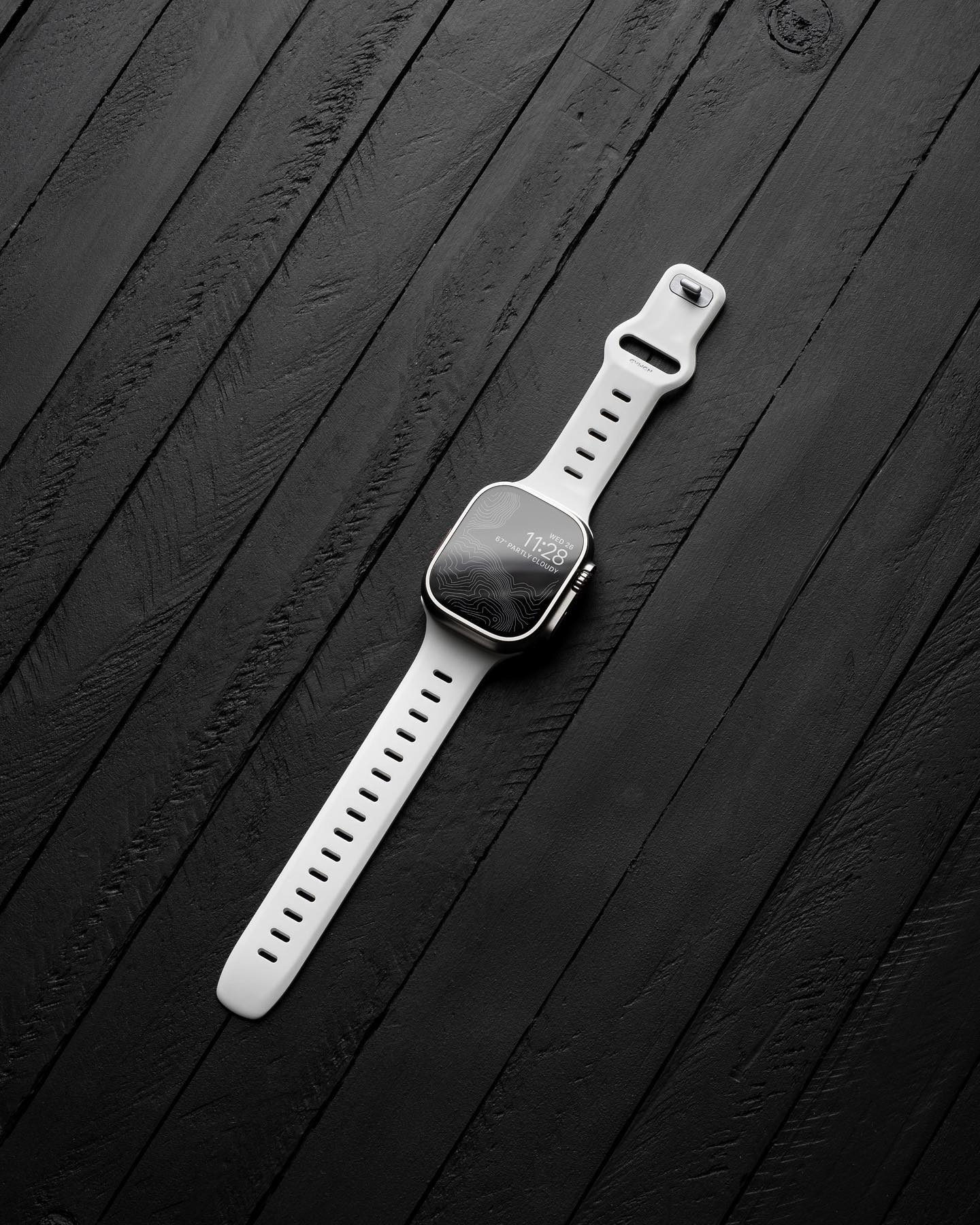 white iwatch on a black deskmat